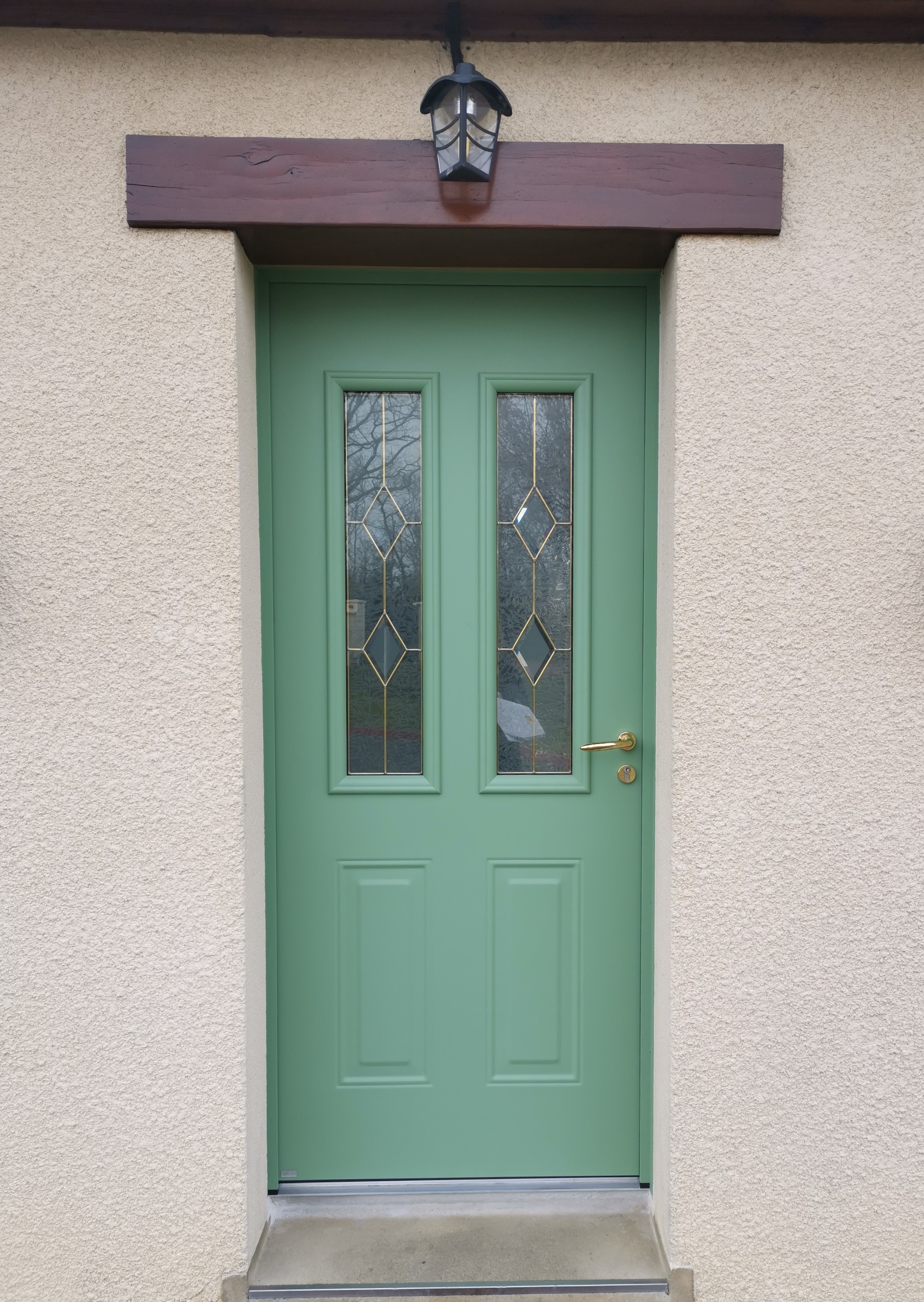 Porte verte avec fenêtres en verre.